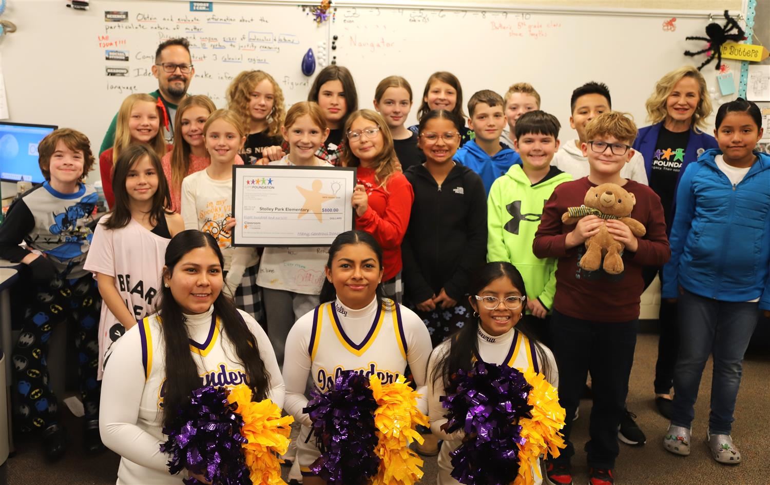 Stolley Park 5th Grade students in Mr. Butters class smiling with a big check from the classroom grant.